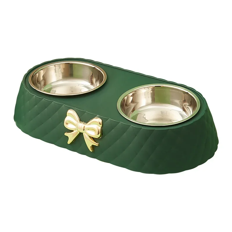 Green stainless steel cat bowl with a bow design displayed on a white background.