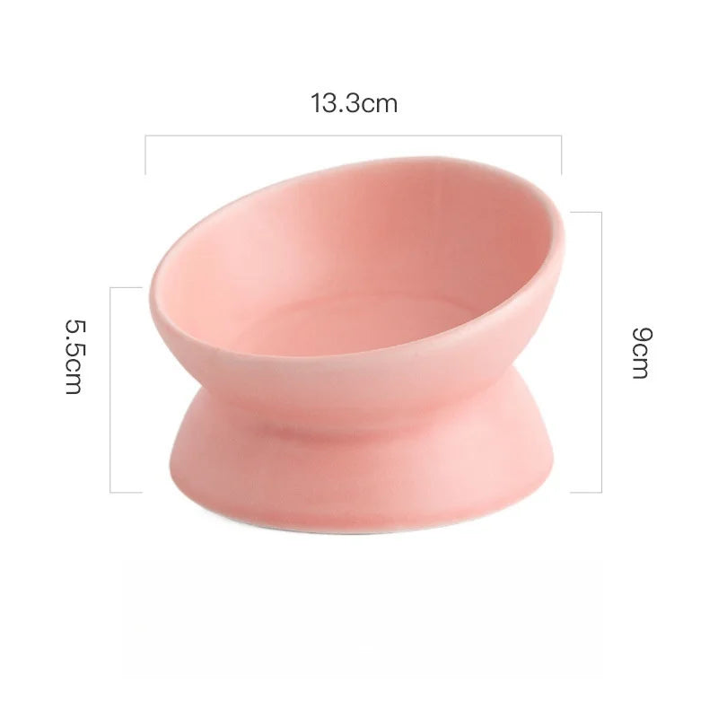 Pink ceramic elevated cat bowl with measurements displayed on a white background.