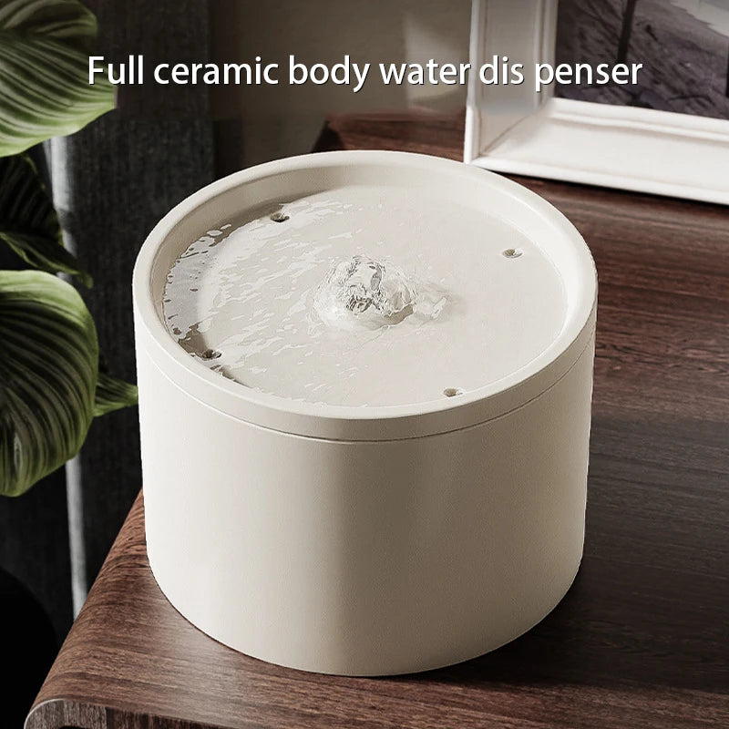 White ceramic water dispenser on a wooden surface with text &