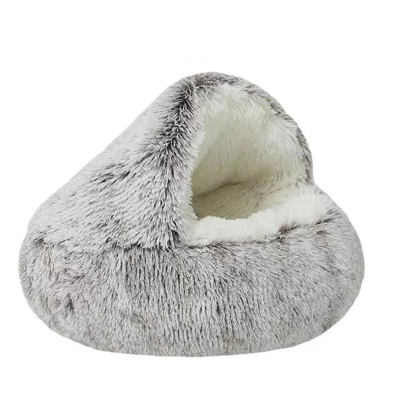 Brown calming cat bed made of long plush displayed on w white background.