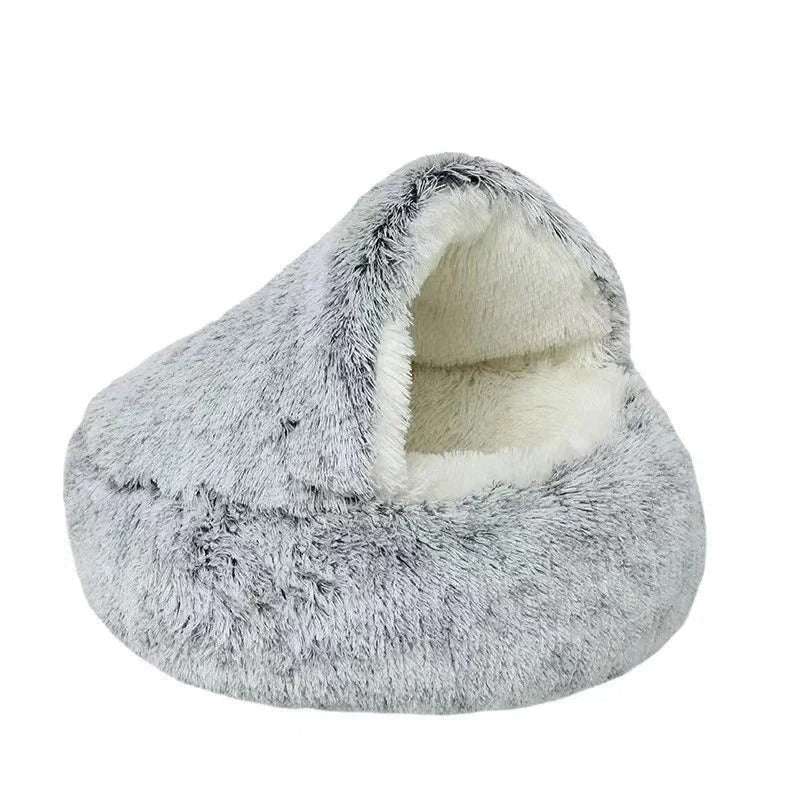 Grey fluffy calming cat bed with white plush interior displayed on a white background.