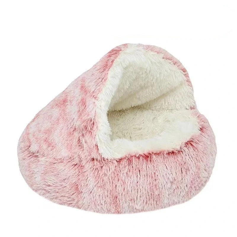 Calming, semi-enclosed plush pink cat bed with white interior displayed on a white background.