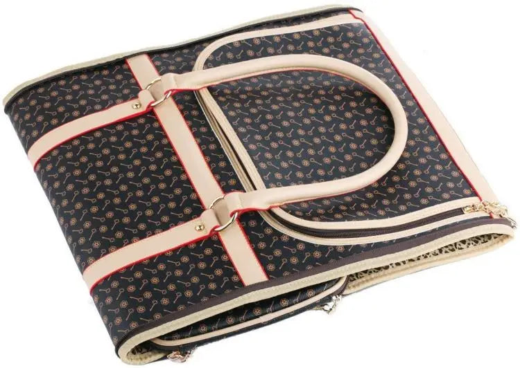 Folded patterned pet carrier with a strap on a white background.
