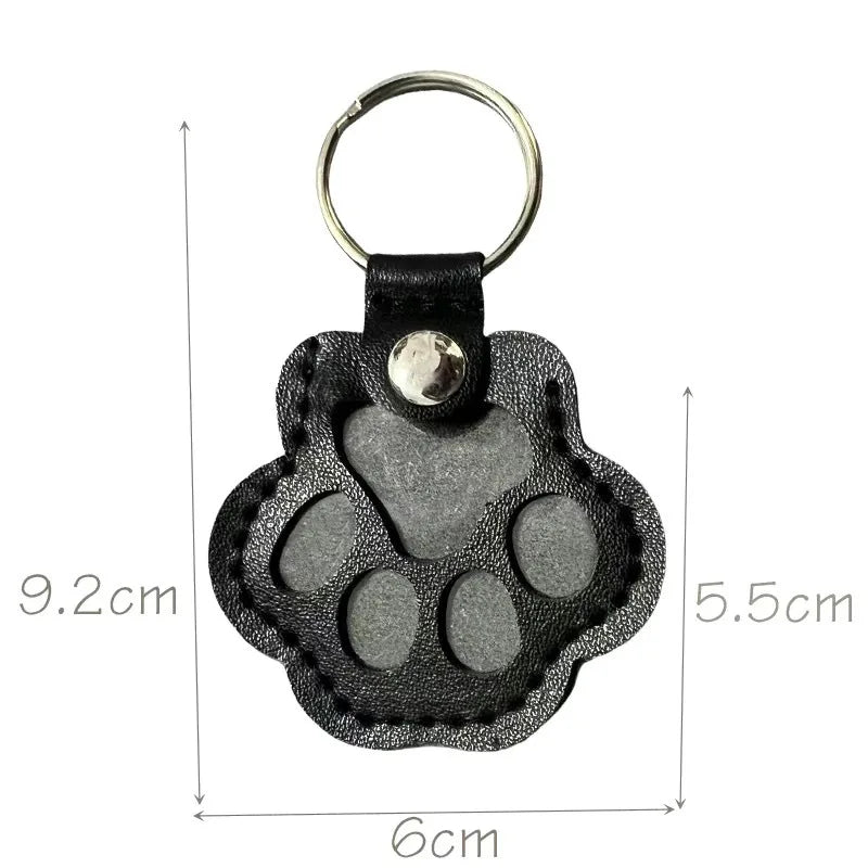 Black paw shape memorial keyring with its measurements displayed on a white background.