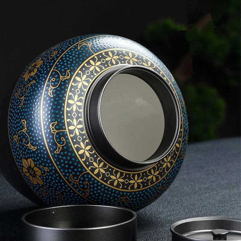 Black pet cremation urn with blue and gold ornament with open lid showing interior for ashes - elegant keepsake for memorial purposes.