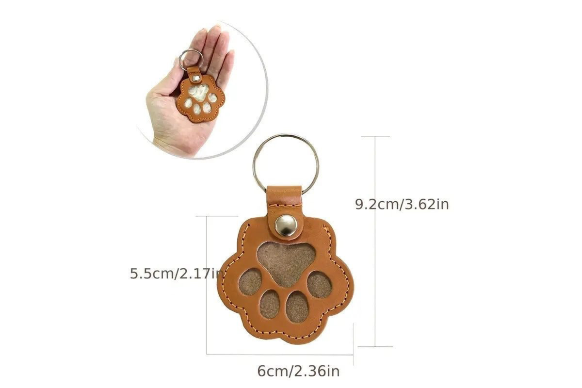 Photo of a pet hair keepsake keyring held in hand and its measurements displayed on a white background.