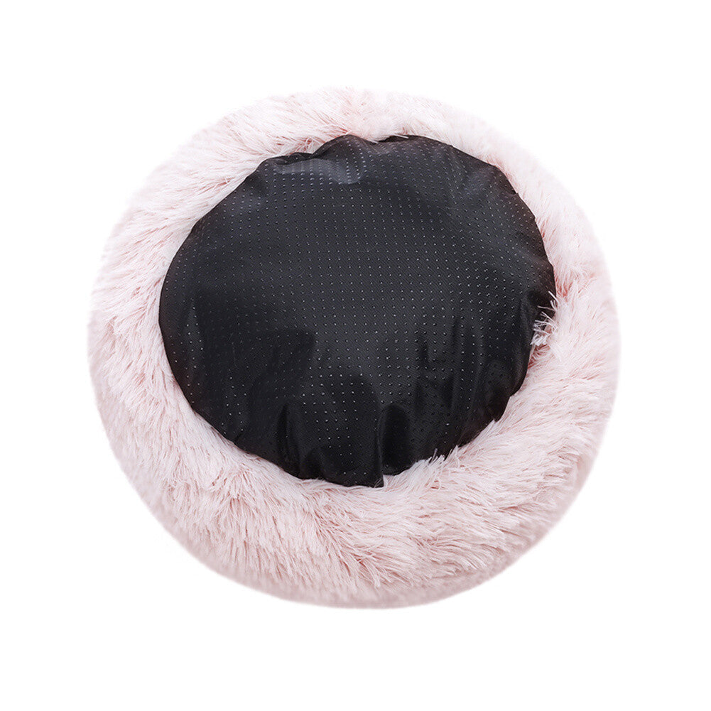 Pink calming soft plush cat bed showing bottom anti-slip surface displayed on a white background.