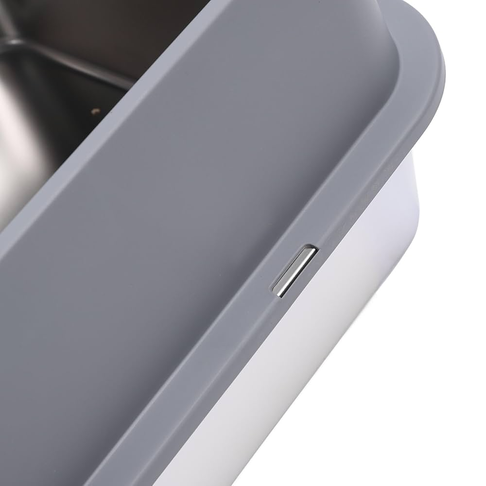 Closeup of a premium stainless steel cat litter box with a grey enclosure on a white background.