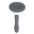 Front view of grey stainless steel self grooming brush for cats displayed on a white background.