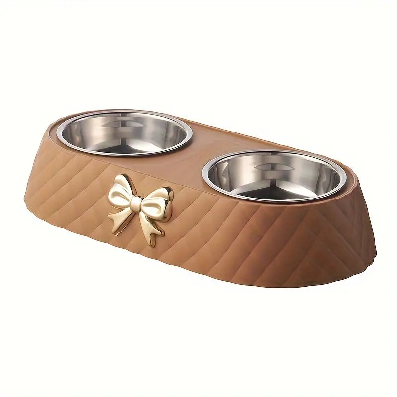 Brown stainless steel cat bowl with a bow design displayed on a white background.