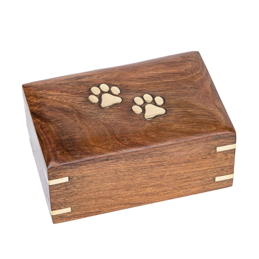 A handmade pet cremation box made from timber with brass paw prints displayed on a white background.