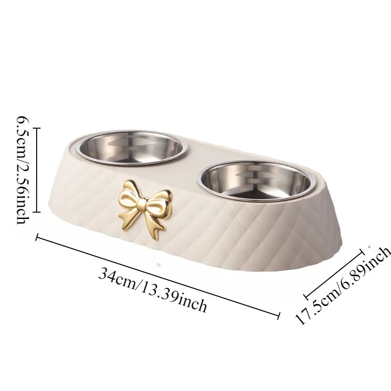 White stainless steel cat bowl with a bow design shown with measurements on a white background.