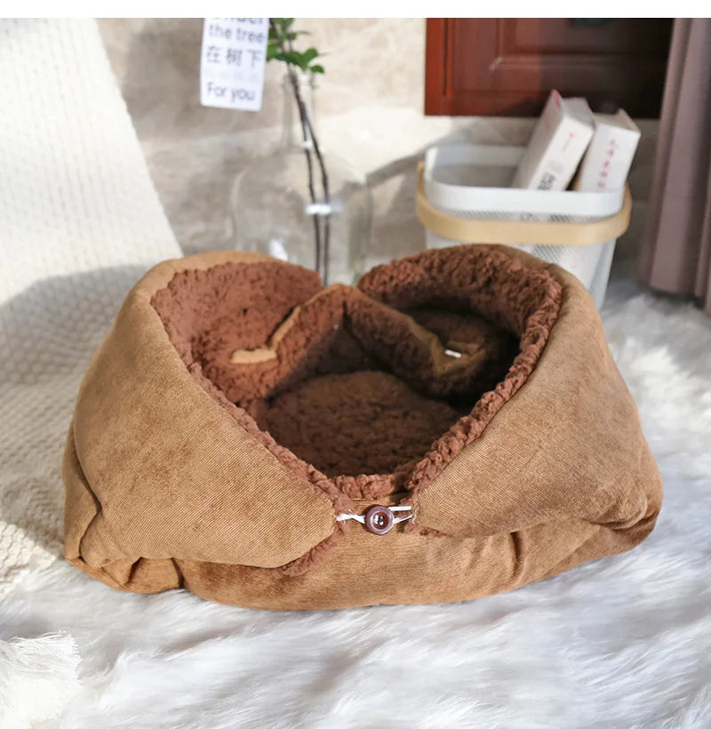 Brown pet bed on a white surface with a blurred background