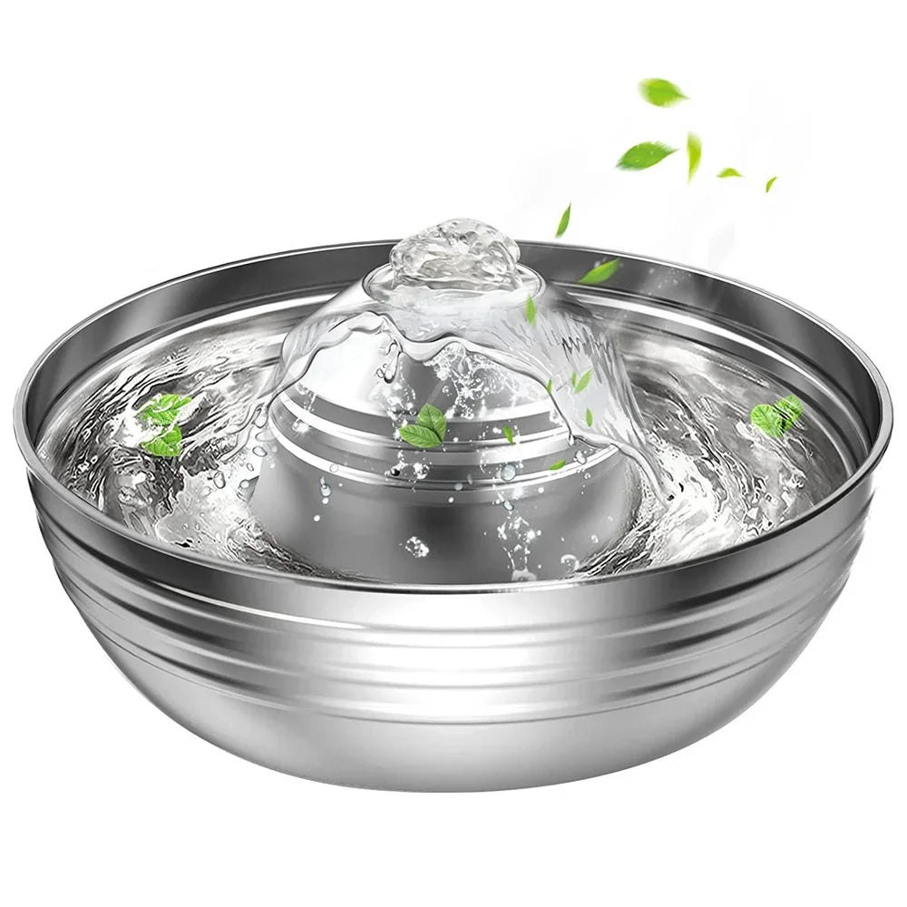 Stainless steel pet water fountain with water flowing and leaves on a white background