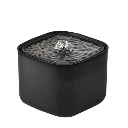 Black pet water fountain with water flowing on a white background
