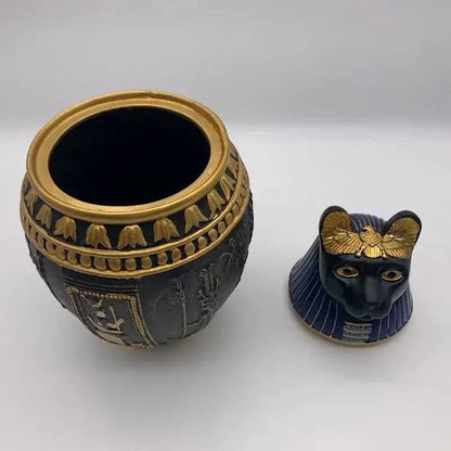 Decorative pet cremation jar portraying Ancient Egyptian goddess Bastet, displayed open on white background. 