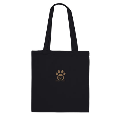 Black cotton tote bag with Gentle Purrs logo print displayed on a white background.