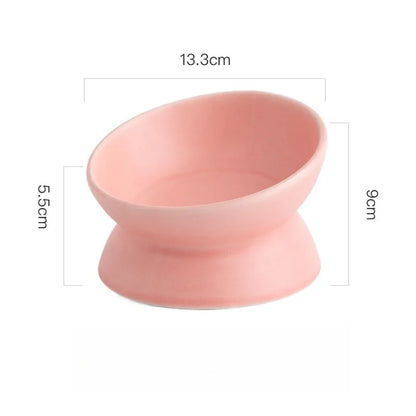 Pink ceramic elevated cat bowl with measurements displayed on a white background. 