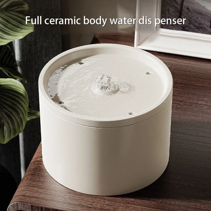 White ceramic water dispenser on a wooden surface with text &