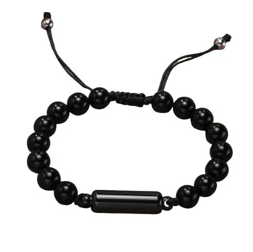 Black onyx bead cremation urn bracelet with adjustable black cord and a cylindrical metal urn pendant in the centre, displayed on a white background
