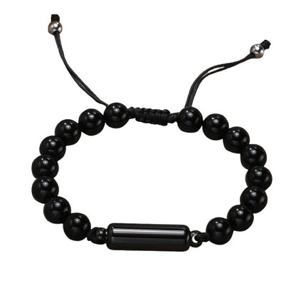 Black onyx bead cremation urn bracelet with adjustable black cord and a cylindrical metal urn pendant in the centre, displayed on a white background
