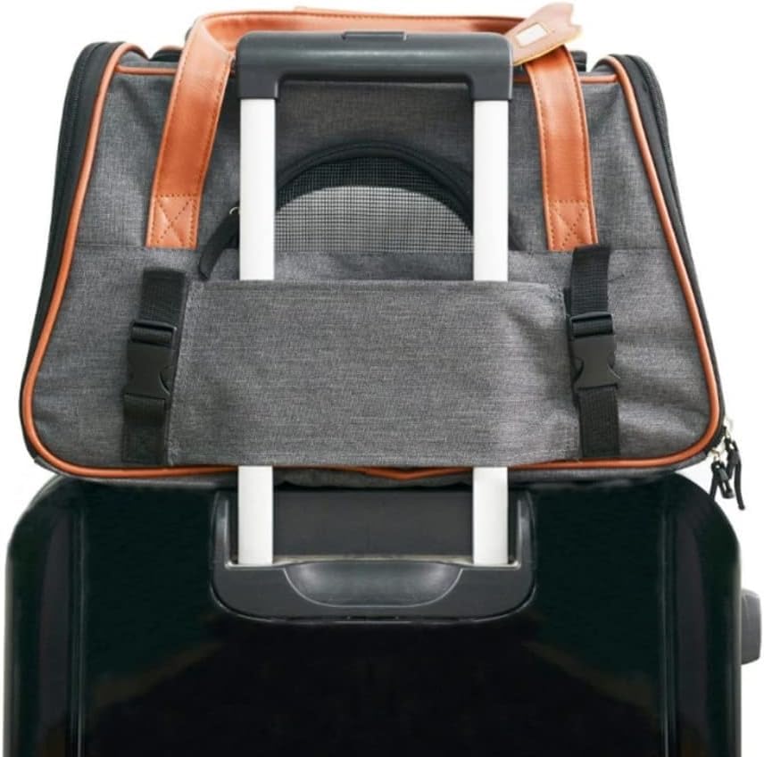 Foldable pet carrier with orange leather handles attached to a suitcase. 