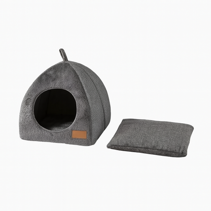 Grey triangular cat cave house with removable washable cushion displayed on a white background.