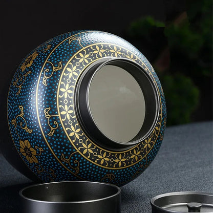 Black pet cremation urn with blue and gold ornament with open lid showing interior for ashes - elegant keepsake for memorial purposes.
