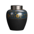 Ceramic black pet cremation urn with a gold and blue ornament displayed on a white background.