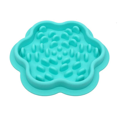Turquoise silicone pet slow feeder displayed on a white bacground.