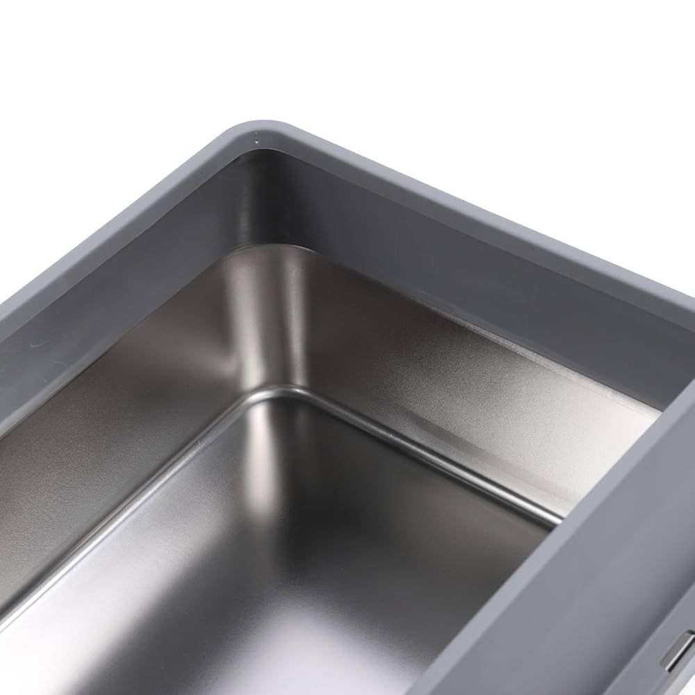 Closeup of a stainless steel tray; a part of a premium enclosed cat litter box on a white background.