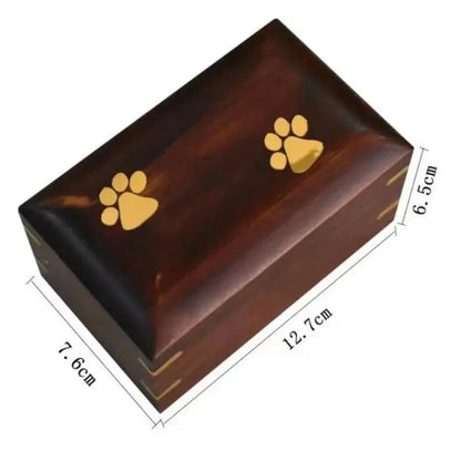 Wooden cremation box with gold paw prints and dimensions on a white background