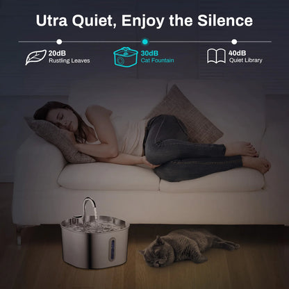 Woman sleeping on a couch with a cat next to a quiet cat fountain, emphasizing its ultra-quiet feature.