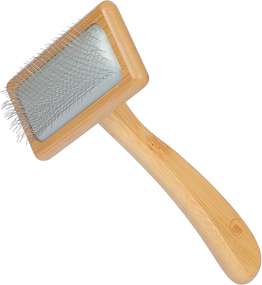 Wooden pet grooming brush with rubber cushion and stainless steel on a white background